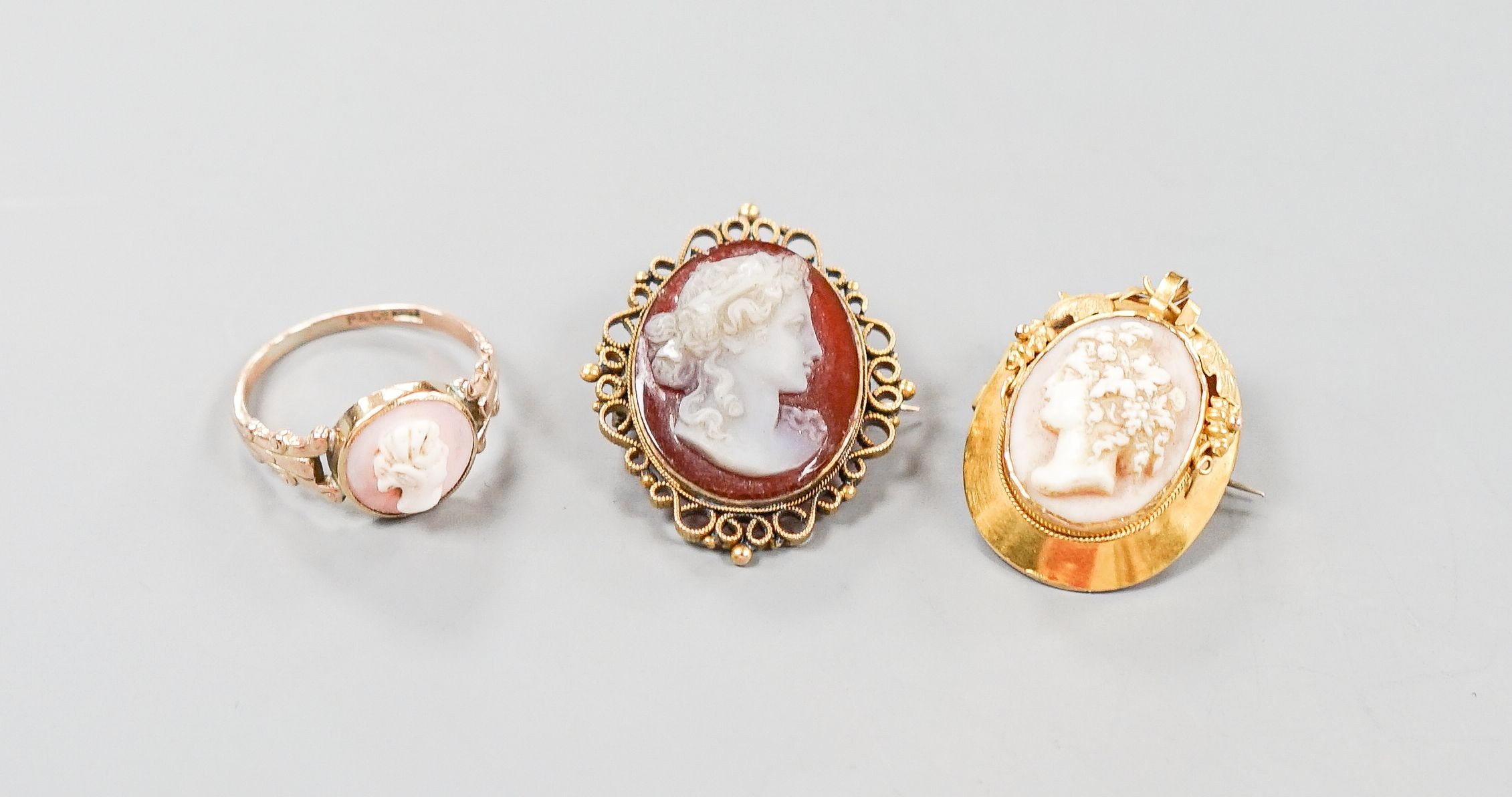 Two yellow metal and cameo set oval brooches, shell and hardstone cameo brooches and a 9ct cameo ring